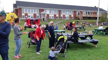 Guests can socialize at this community gathering space with picnic tables and a lively atmosphere.