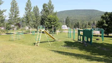 A playground with various play structures including a slide and climbing frames.