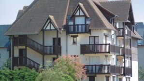 A multi-story building with a steeply pitched roof, dormer windows, and balconies. - Résidence Lagrange Vacances Cabourg (Cabourg)