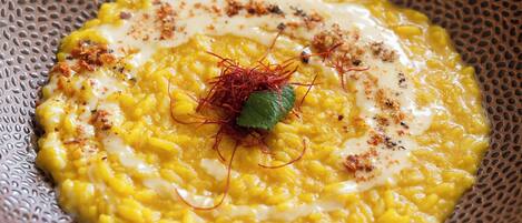 A bowl of food with a decorative garnish on a textured plate.