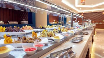 A buffet with various dishes and condiments.