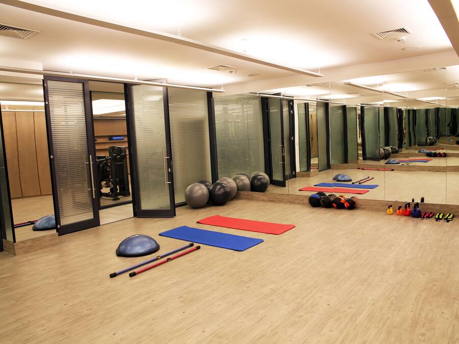 A gym with exercise mats, balls, and weights.
