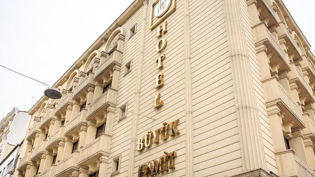 A hotel facade with a classic architectural design, featuring a prominent sign and multiple balconies. - Hotel Buyuk Hamit (Istanbul)