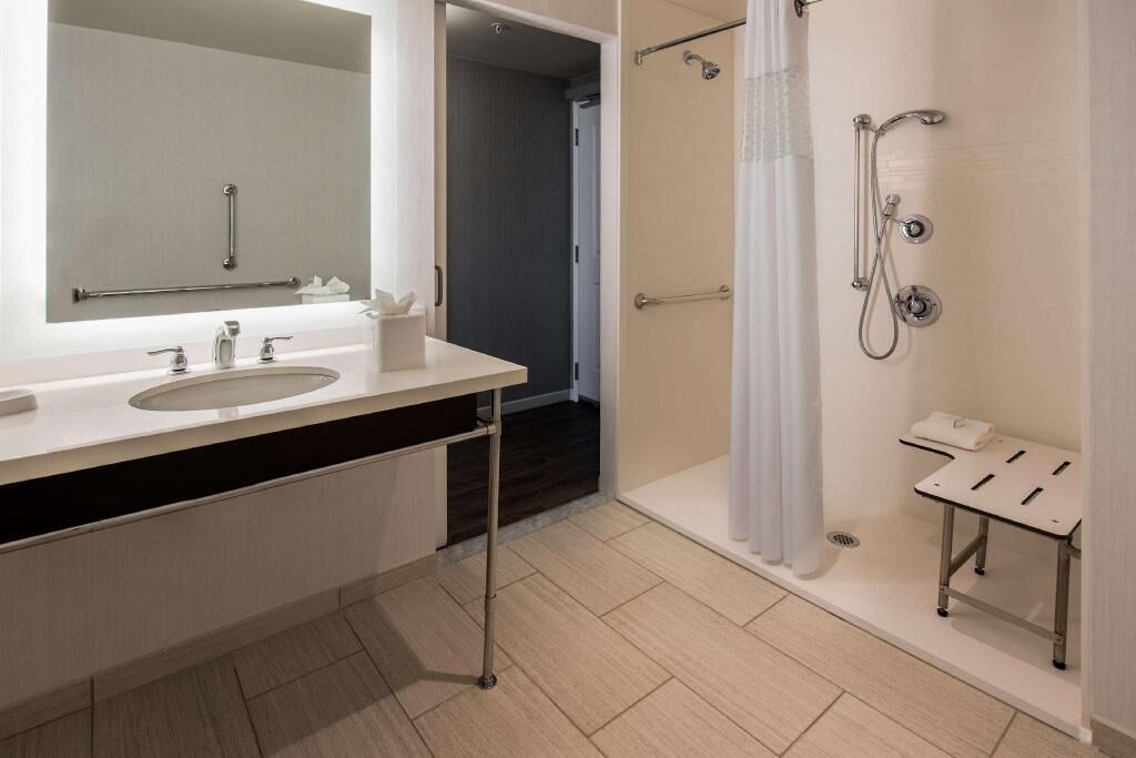 Shower, designer toiletries, hair dryer, towels