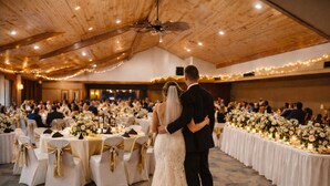 A wedding reception with round tables, white tablecloths, and floral centerpieces. - The Round Barn Lodge (Spring Green)