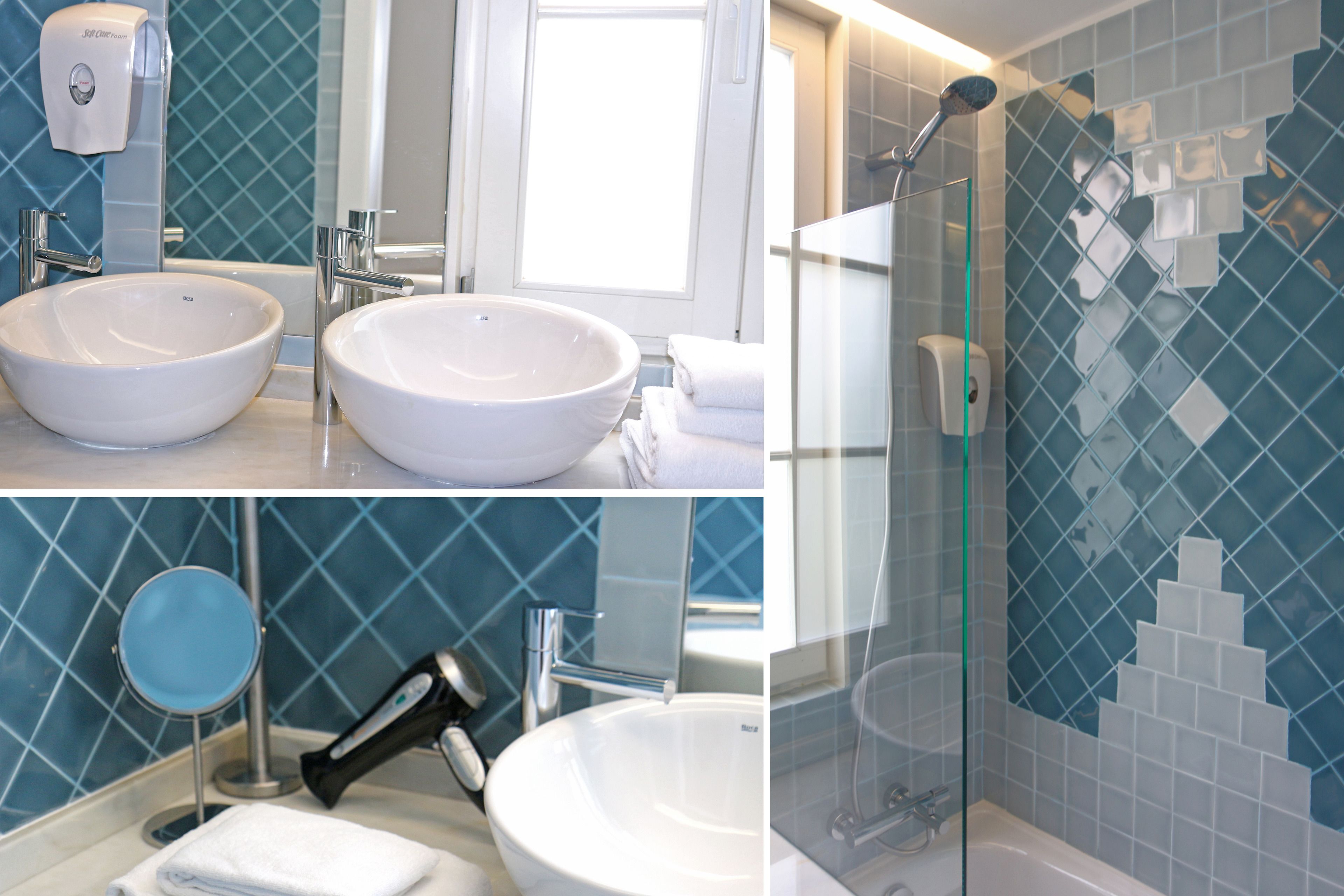 A bathroom with two sinks, a mirror, a towel rack, and a shower area.
