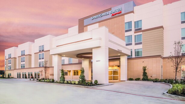 A modern hotel with a covered entrance, multiple floors, and a Marriott logo. - Springhill Suites Houston Westchase (Houston)