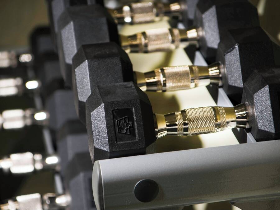 A close-up of a mechanical device with multiple black hexagonal components and brass connectors.