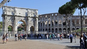 A historic Roman amphitheater with multiple arches and a large central archway. - Madonna de’ Monti Suites  (Rome)