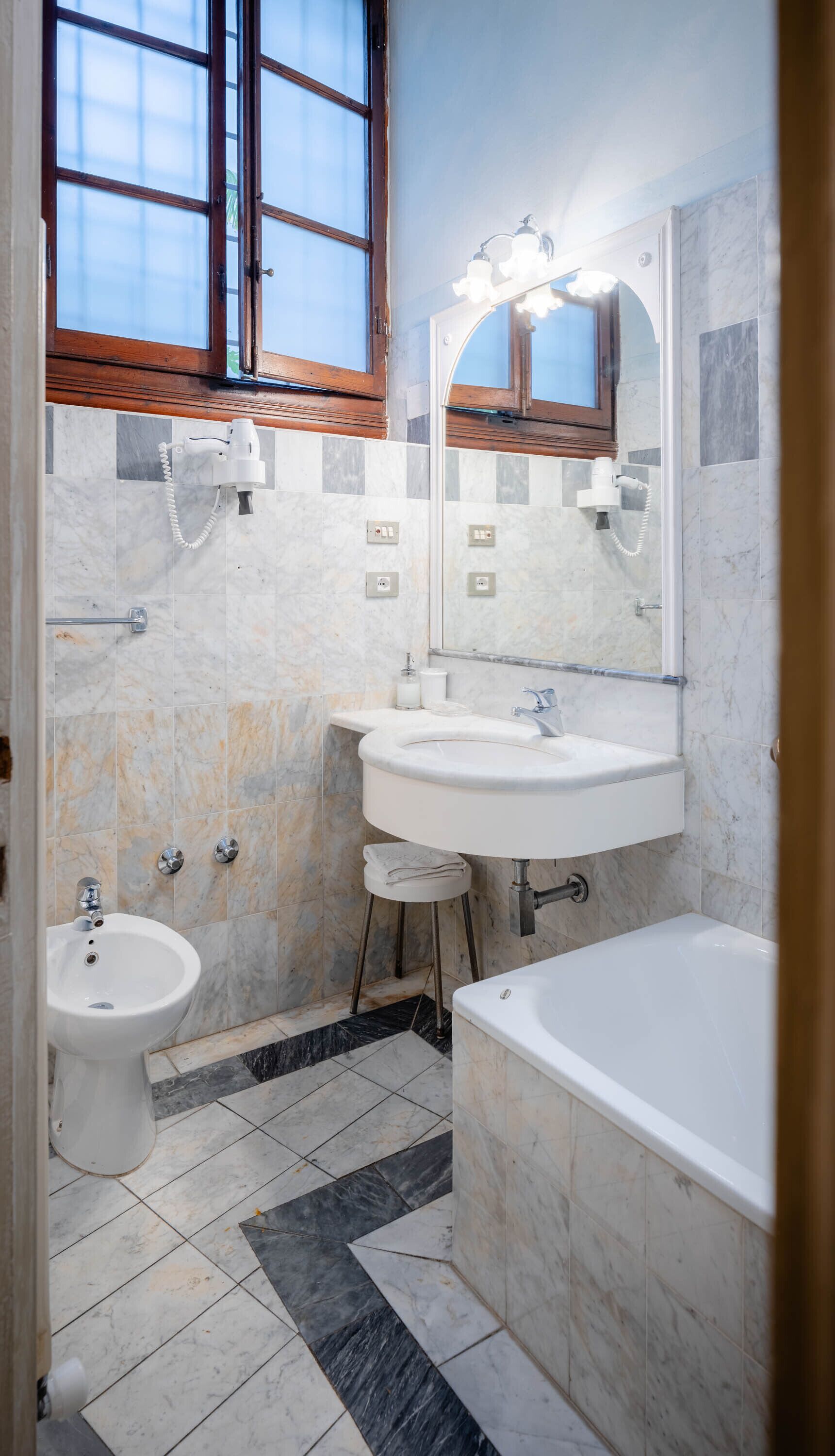 Un baño con lavamanos, bidé y bañera.
