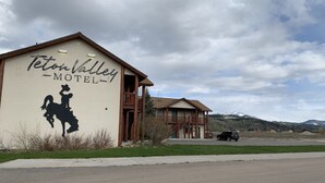 A building with a sign reading "Teton Valley Motel" and a silhouette of a cowboy on a horse. - Teton Valley Motel (Victor)