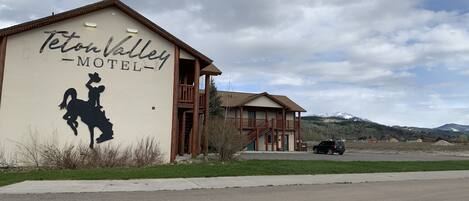 A building with a sign reading "Teton Valley Motel" and a silhouette of a cowboy on a horse.