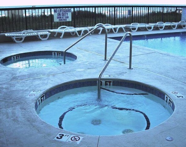 A pool with two hot tubs, each marked with a depth of 3 feet.
