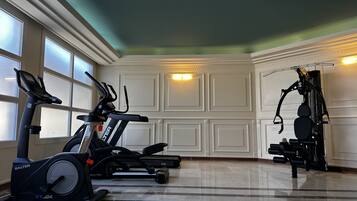 A home gym with stationary bikes and an elliptical machine.