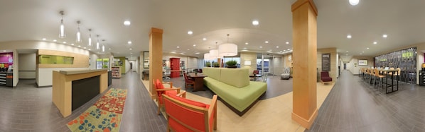 Welcome to our hotel lobby, featuring a spacious reception area with a comfortable seating space and dining area.