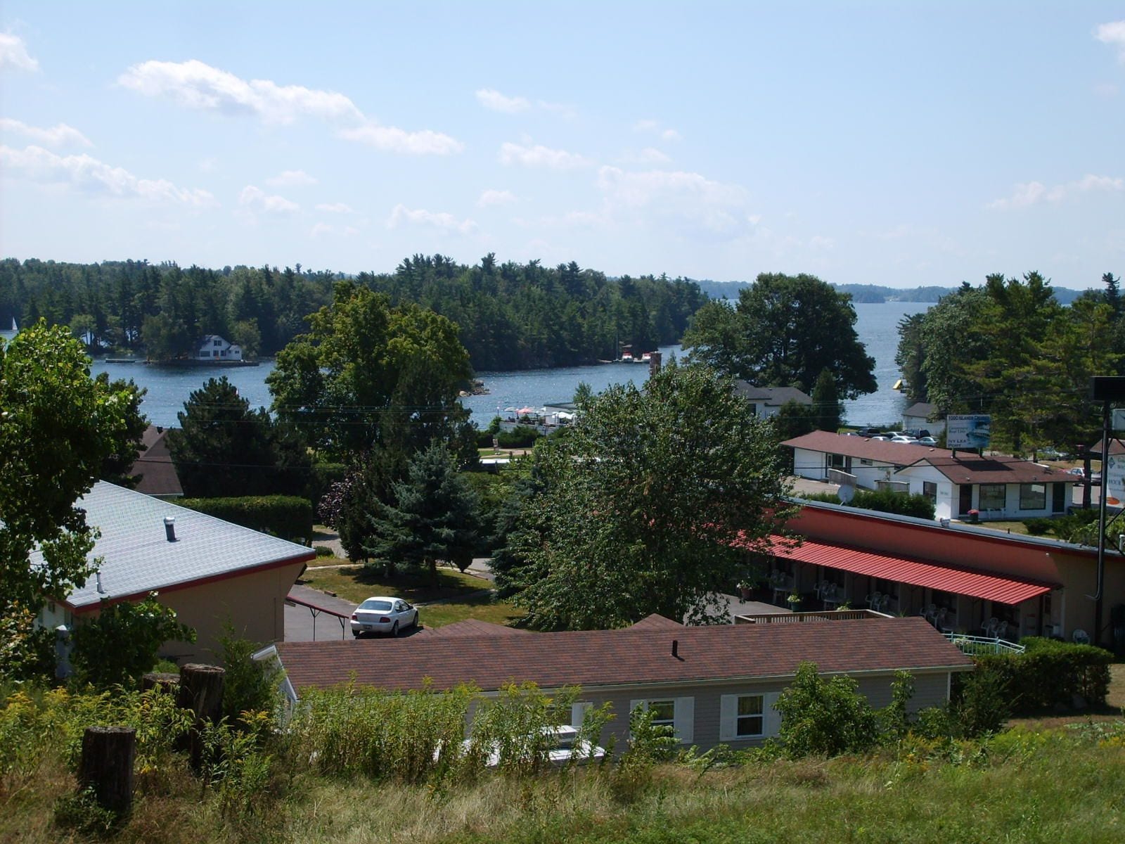 A residential area with houses, a dock, and a lake.
