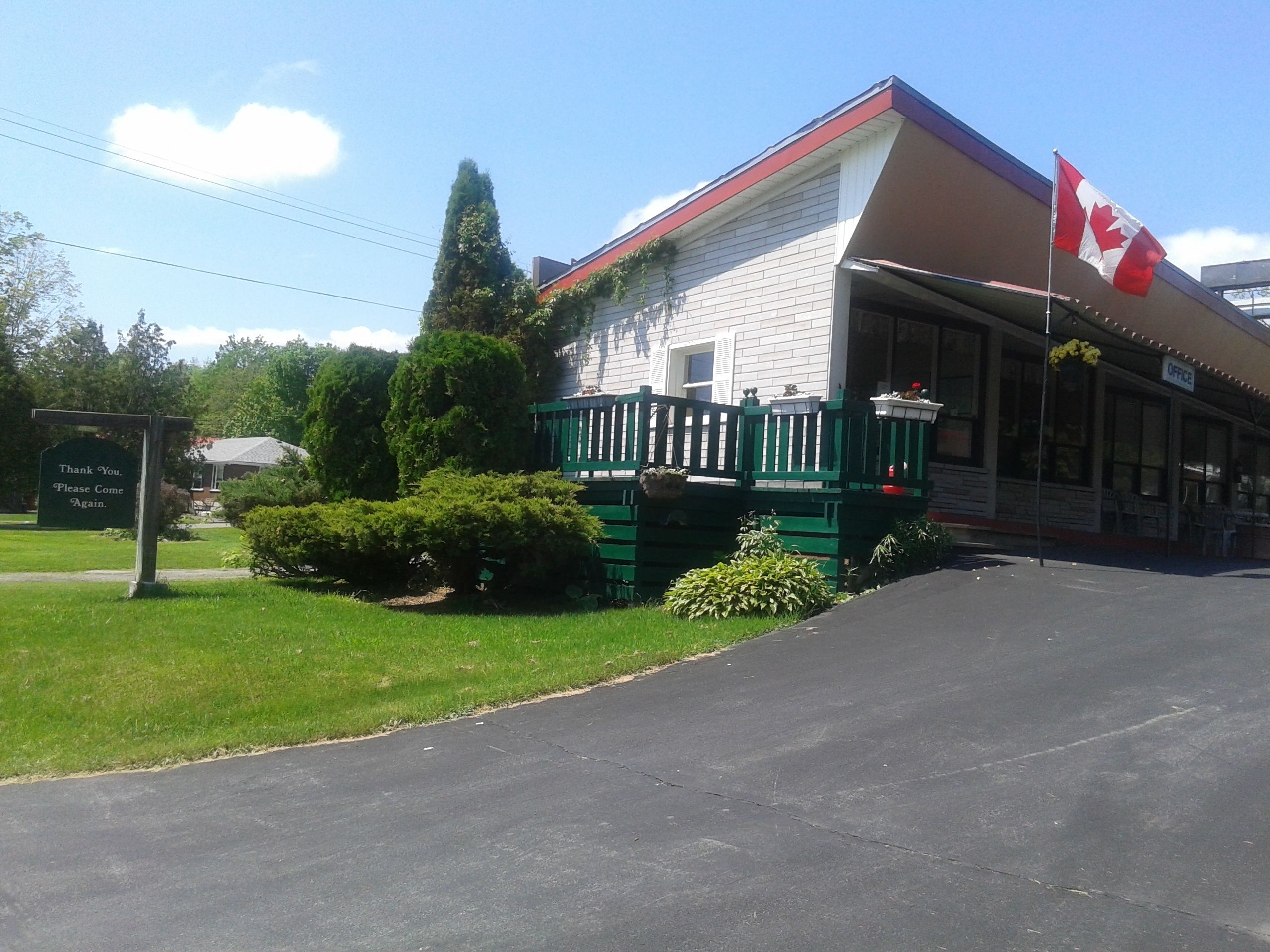 A building with a porch and a Canadian flag.