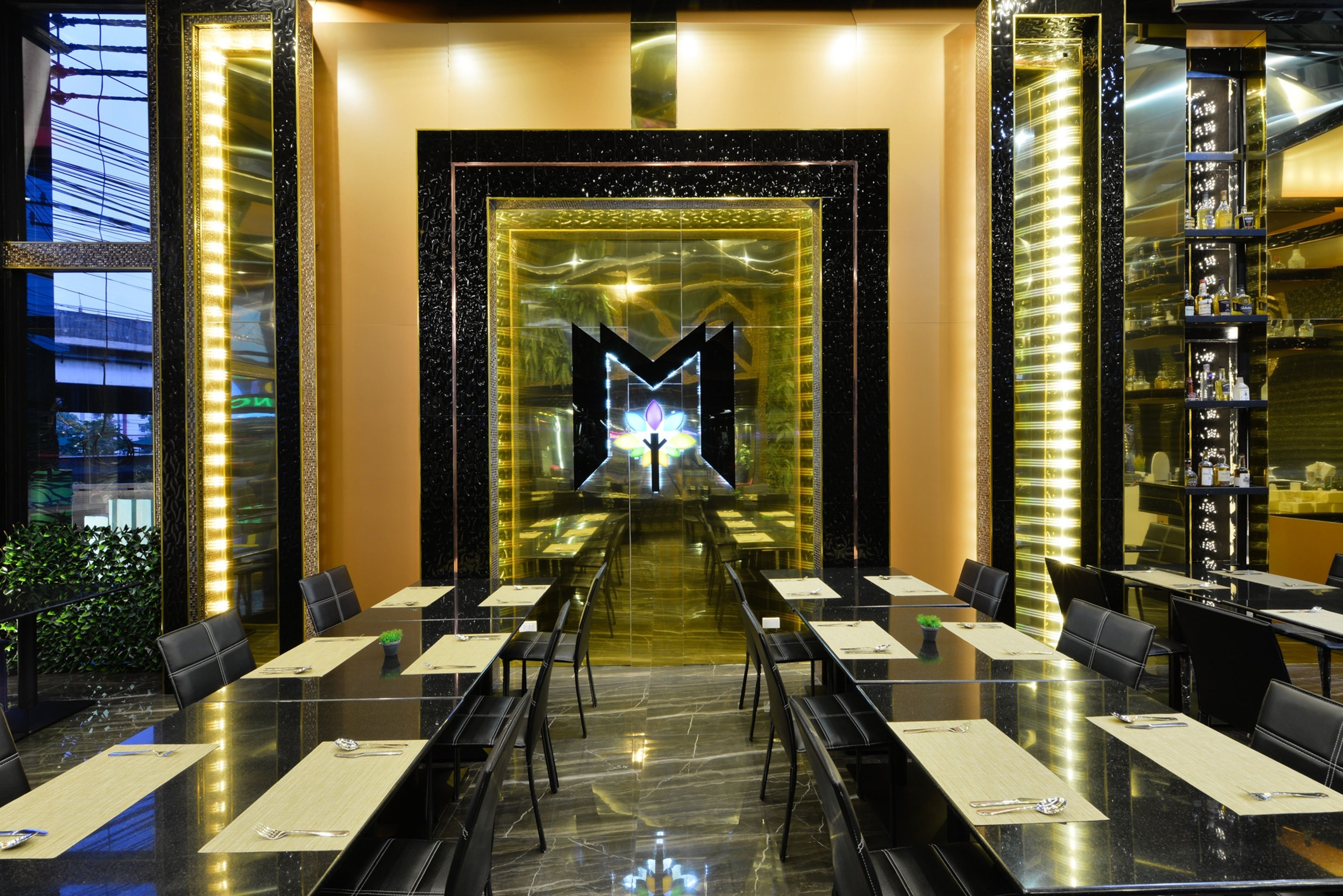 A conference room with a long table, chairs, and a decorative wall feature.