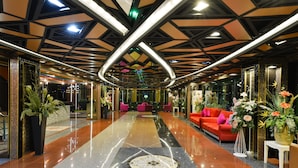 A spacious lobby with a polished floor, a central seating area, and modern lighting fixtures. - Media Hotel & Residence (Bangkok)