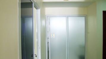 A hallway with a double door, a handicap accessibility sign, and a directional sign indicating restrooms.