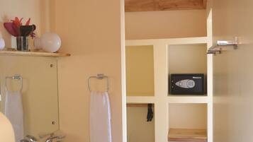 A bathroom with a white sink, a mirror, and a shower area.