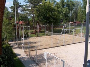 Guests can enjoy a game of tennis on the outdoor court surrounded by lush greenery and scenic views.