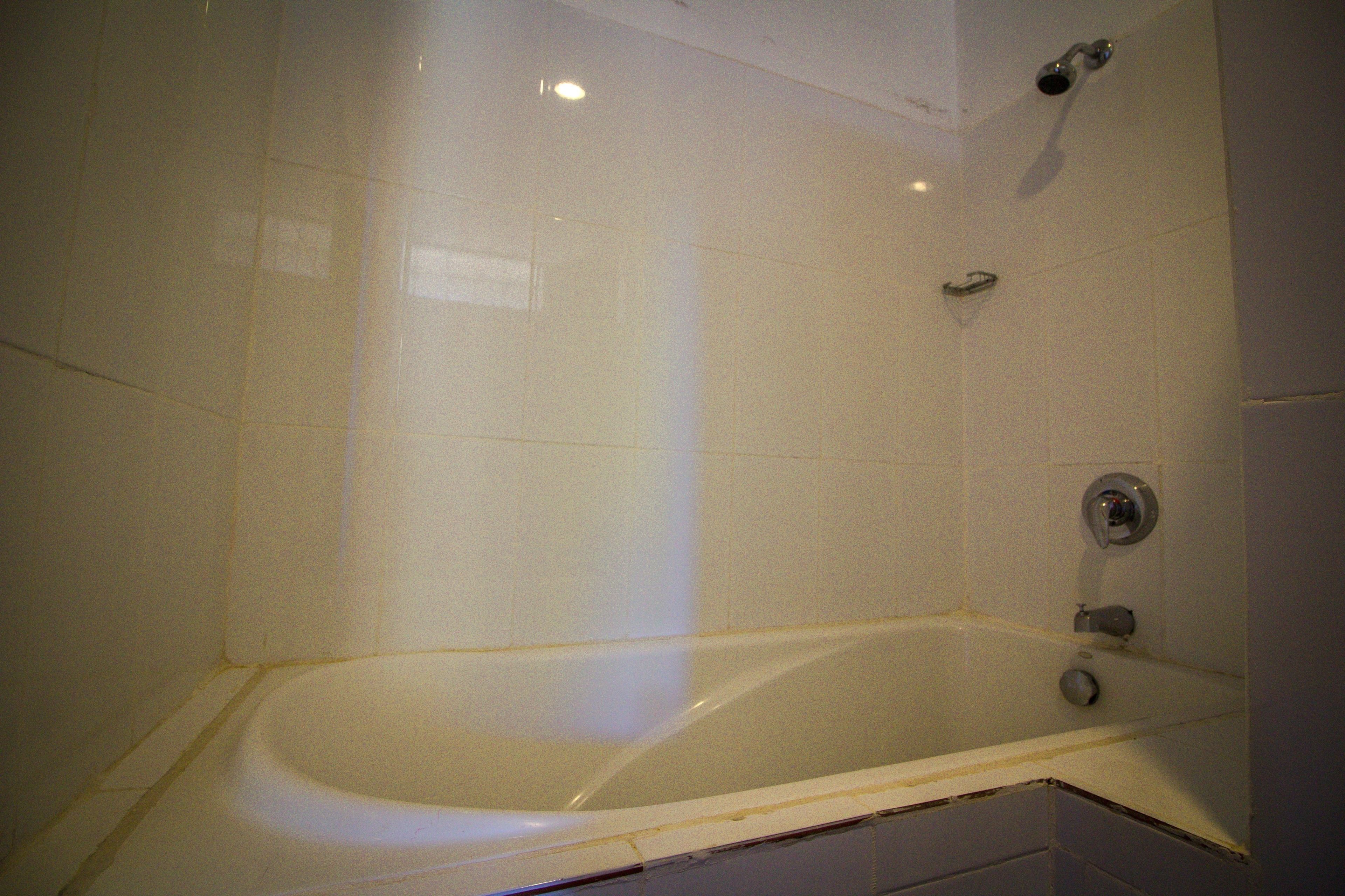 A bathroom with a bathtub, a shower, and a toilet.