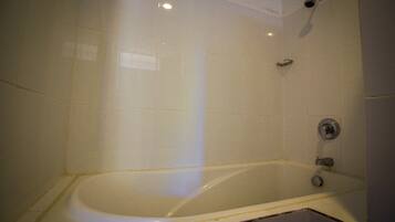 A bathroom with a bathtub, a shower, and a toilet.