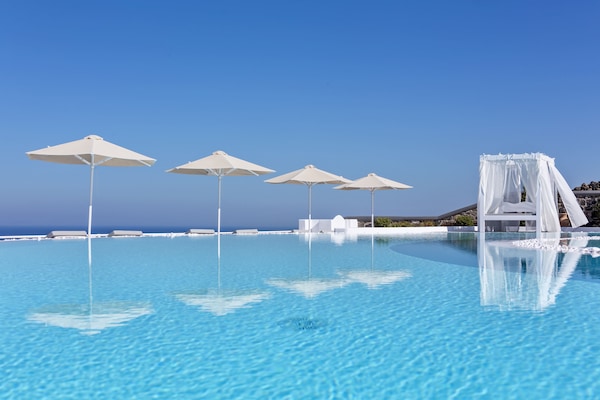 Outdoor pool, an infinity pool, pool umbrellas, sun loungers