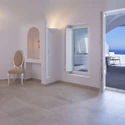 Relax in comfort with a sofa, coffee table, and armchair, offering a serene ocean view.