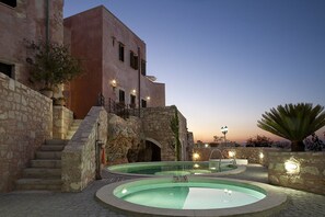 Una piscina al aire libre de temporada, sombrillas