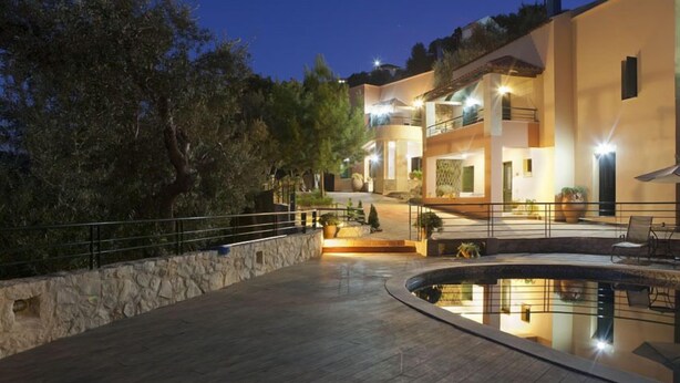 A modern two-story building with a pool, stone walls, and outdoor lighting. - Kastellos Village - Agathes Houses (Apokoronas)