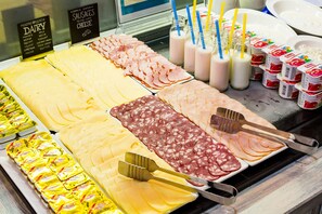 A deli counter with various cheeses, meats, and dairy products. - Ibis Styles Lviv Center (Lviv)