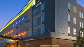 A modern hotel with a flat roof, large windows, and a prominent 'Aloft' sign. - Aloft by Marriott College Station (College Station)