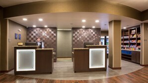 A reception area with two counters, a check-in desk, and a self-service kiosk. - Best Western Plus Lincoln Inn & Suites (Lincoln)
