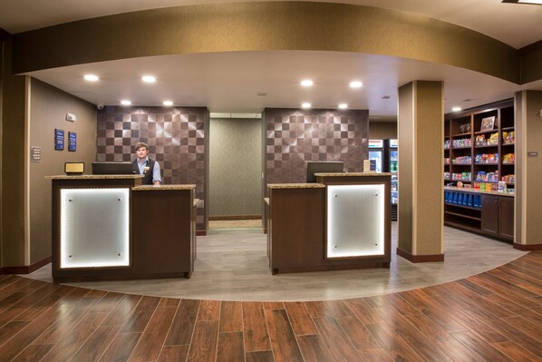 A reception area with two counters, a check-in desk, and a self-service kiosk.