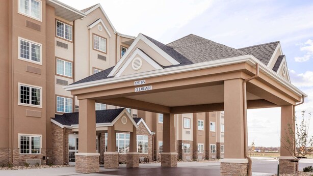 A multi-story hotel with a covered entrance labeled "12FT GIN CLEARANCE." - Microtel Inn & Suites by Wyndham West Fargo Medical Center (West Fargo)