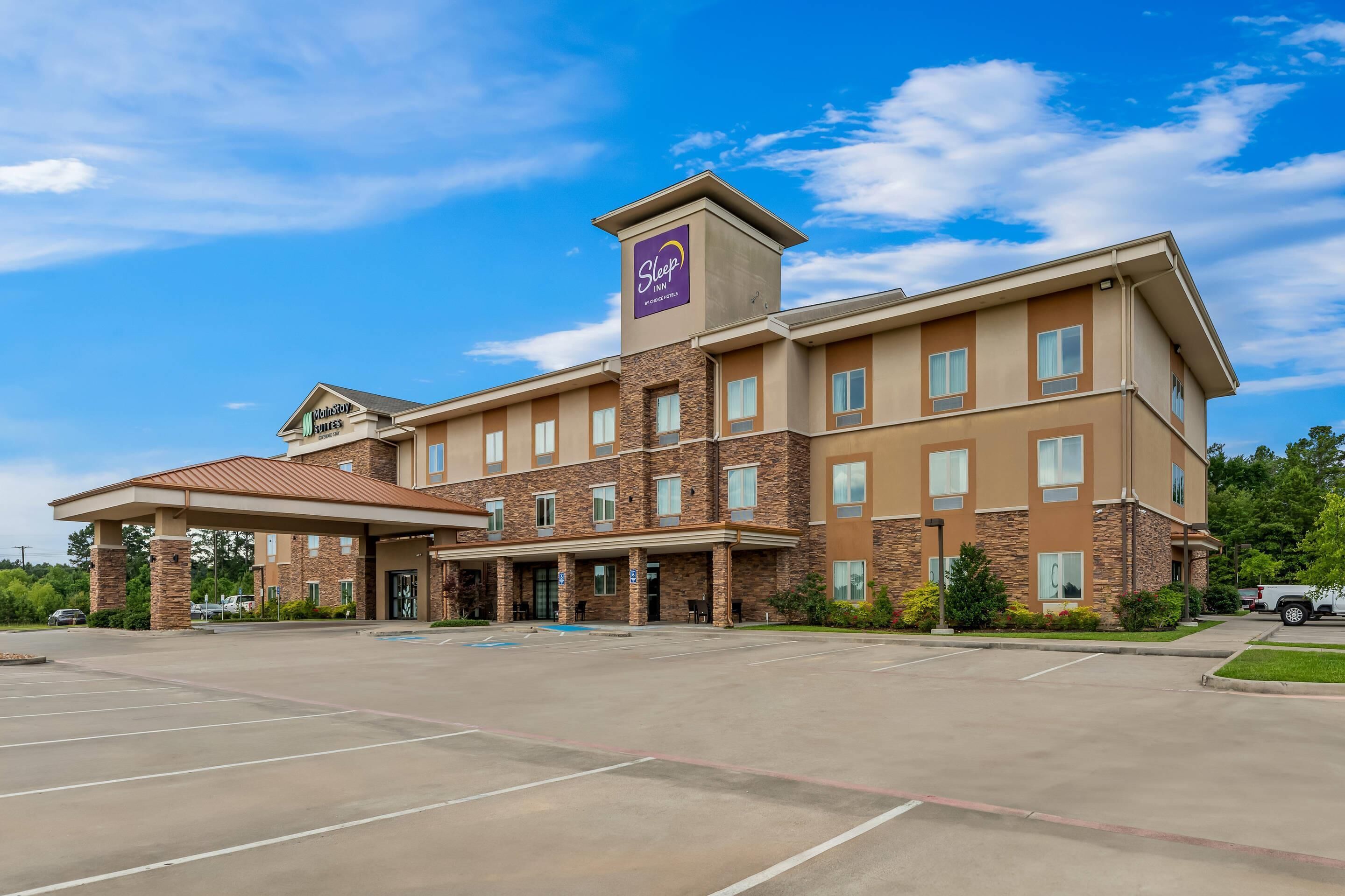 A Sleep Inn hotel with a brick facade, multiple windows, and a covered entrance.