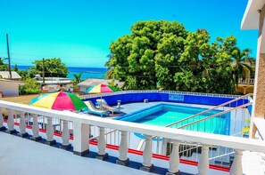 Outdoor pool, open 9:00 AM to 6:00 PM, pool loungers
