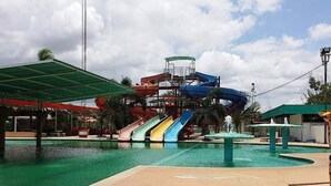 A water park with multiple slides and a pool. - Lita Place (Roi Et)