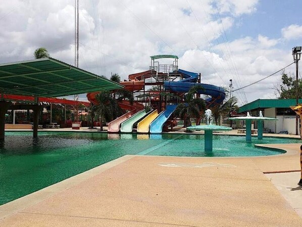 A water park with multiple slides and a pool.