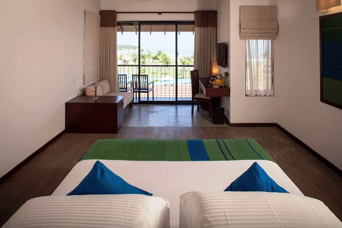 Deluxe Double Room, 1 Bedroom, Partial Ocean View, Beachside | Minibar, in-room safe, desk, blackout drapes