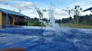 Outdoor pool, an infinity pool, pool loungers