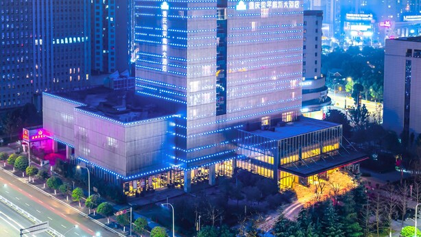 A modern building with multiple floors, large windows, and a prominent entrance. - Days Hotel By Wyndham Chongqing Liangping (Chongqing)