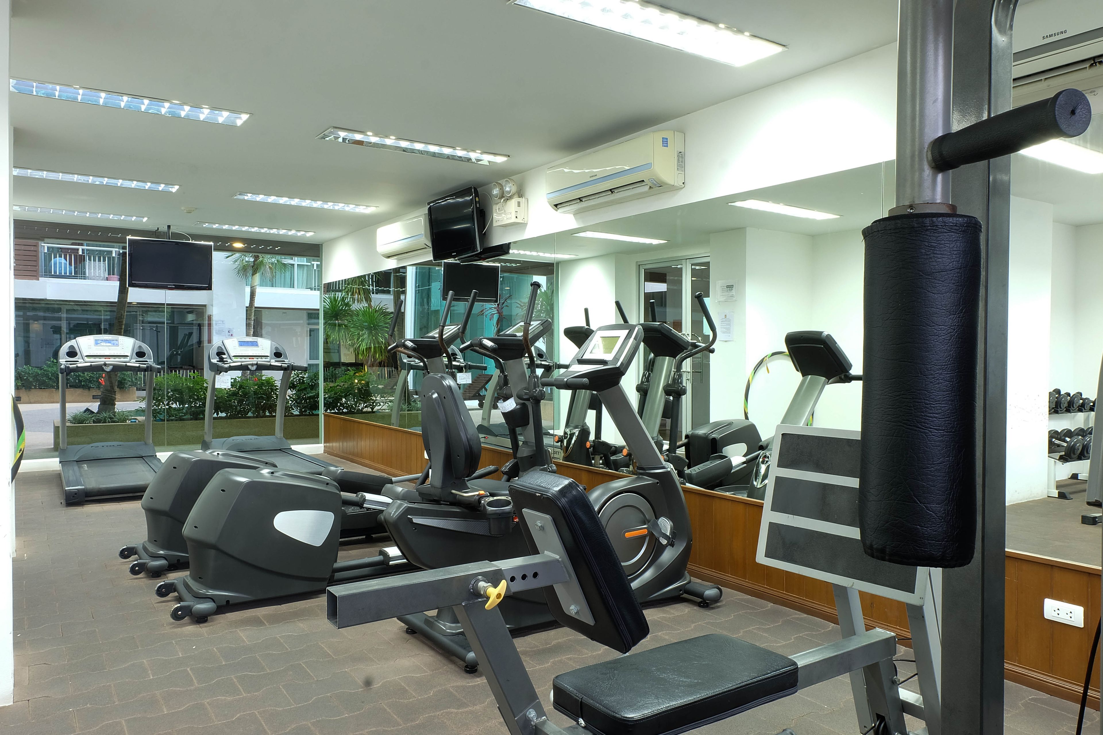 A gym with treadmills, elliptical machines, and weight equipment.