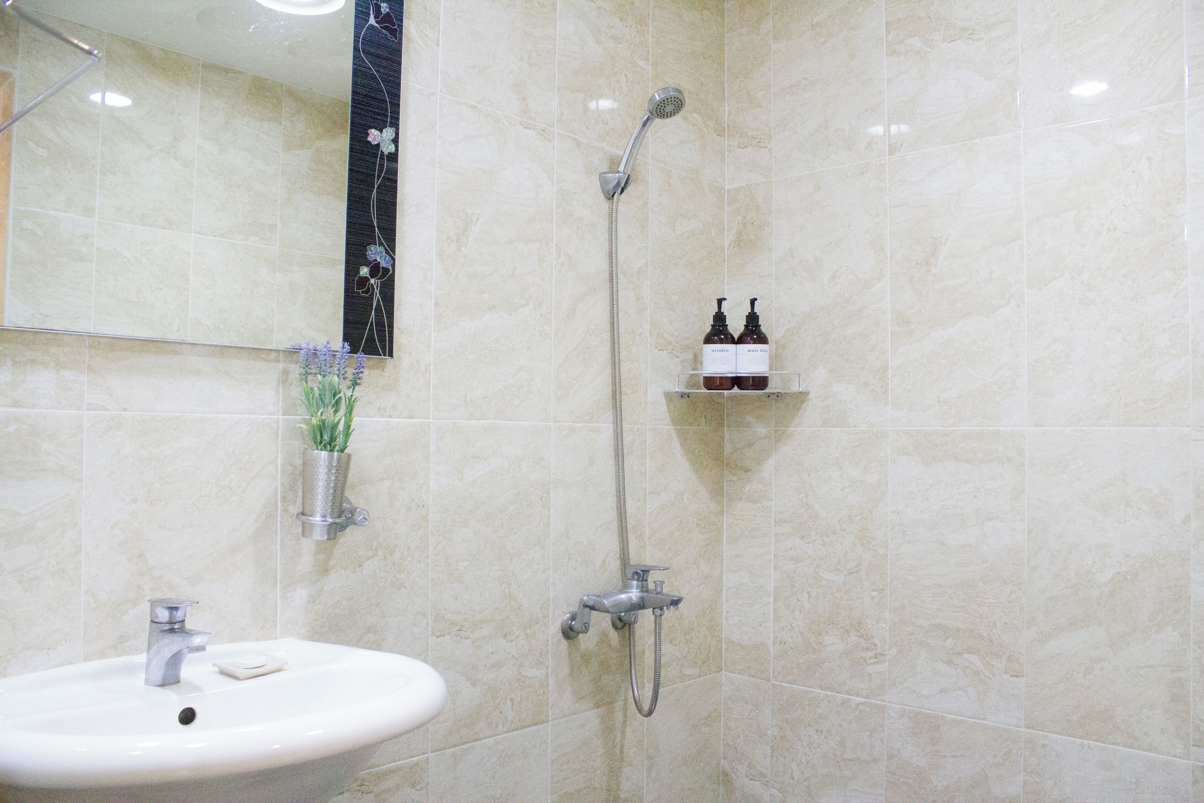 resort room | bathroom | shower, hair dryer, slippers, towels