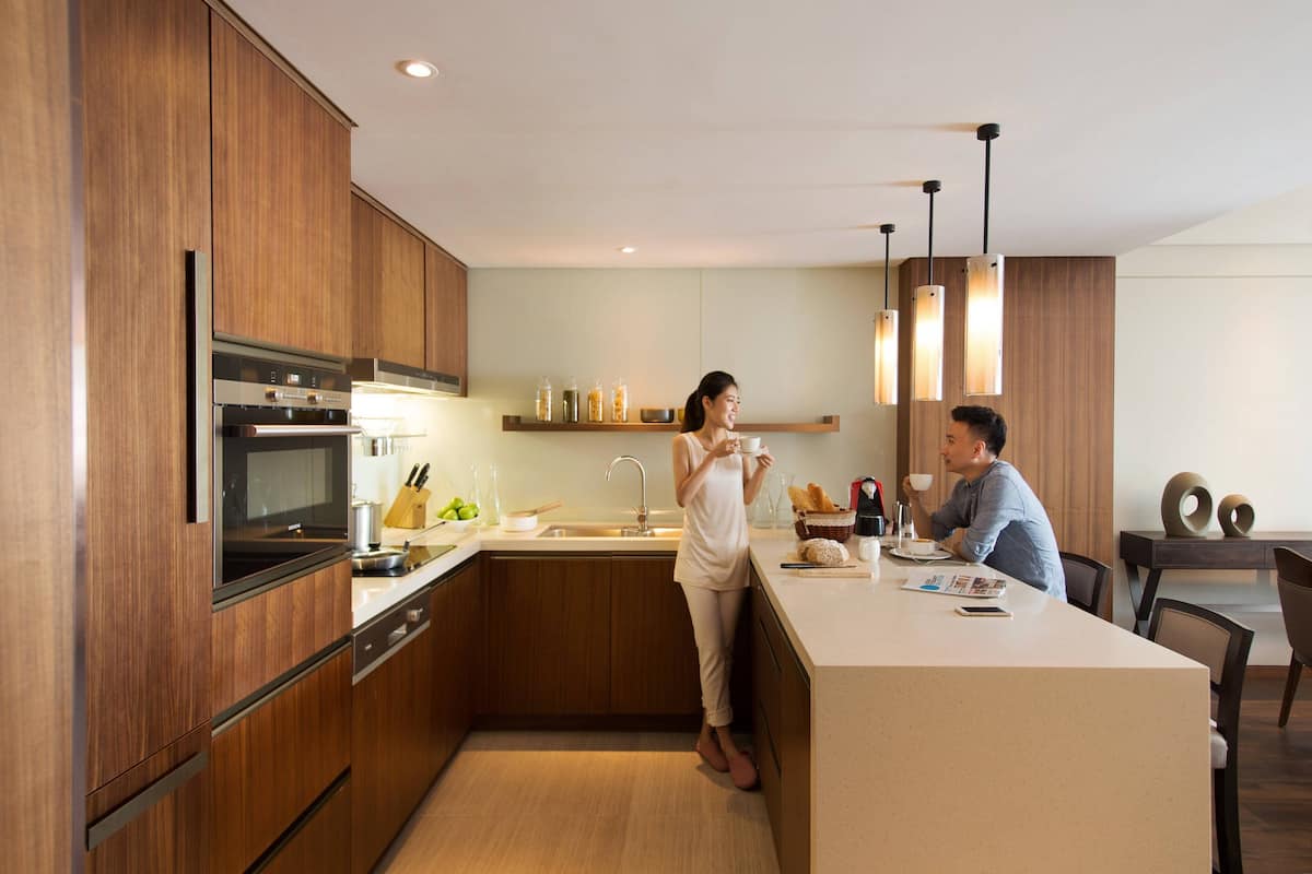 A modern kitchen with wooden cabinets, stainless steel appliances, and a central island.