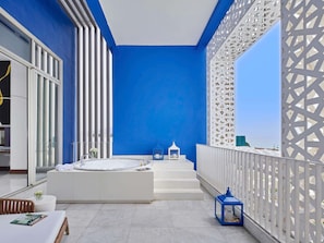 A modern bathroom with a large bathtub, a white sink, and a glass shower enclosure. - Sofitel Tamuda Bay Beach and Spa (M'diq)