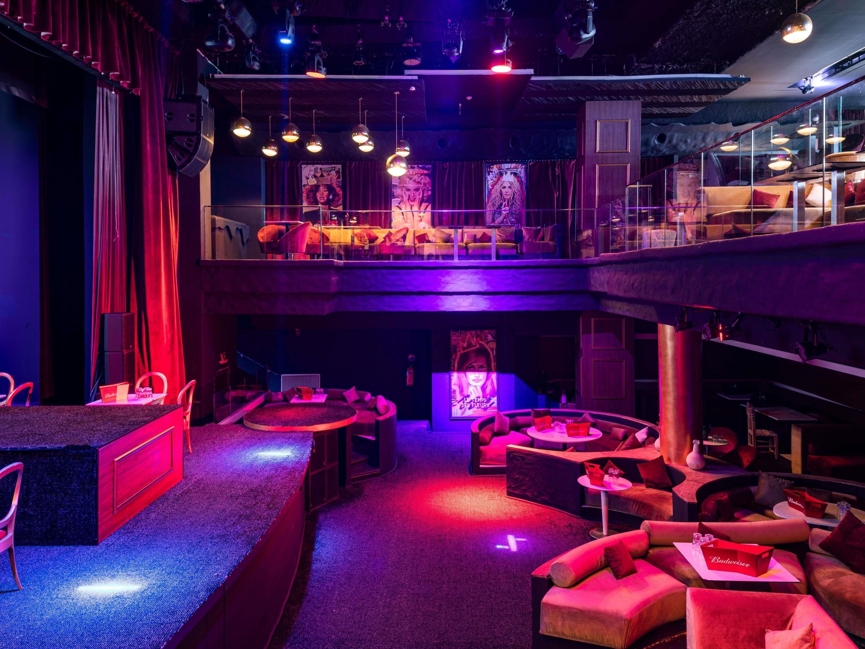 A multi-level lounge area with seating arrangements and a bar.