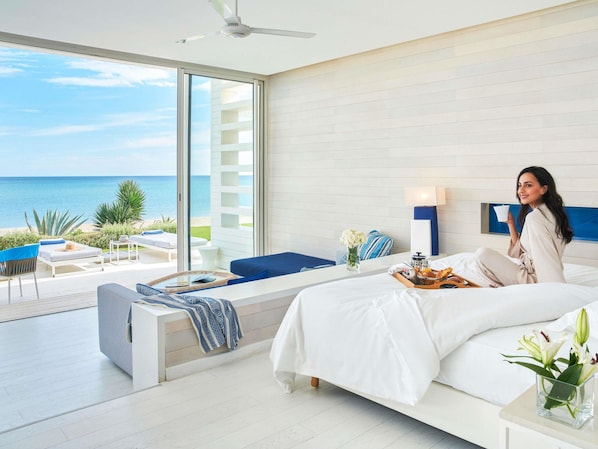 A modern hotel room with a large bed, a seating area with a view of the sea, and a balcony. - Sofitel Tamuda Bay Beach and Spa (M'diq)